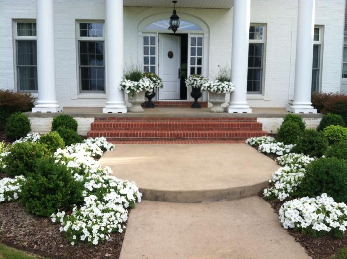 We created this white flower theme landscape to showcase the entry way to a home in Rector. We worked closely with the homeowner to bring her vision to life.  